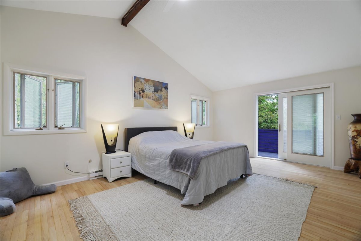 Spacious primary bedroom with access to a private balcony