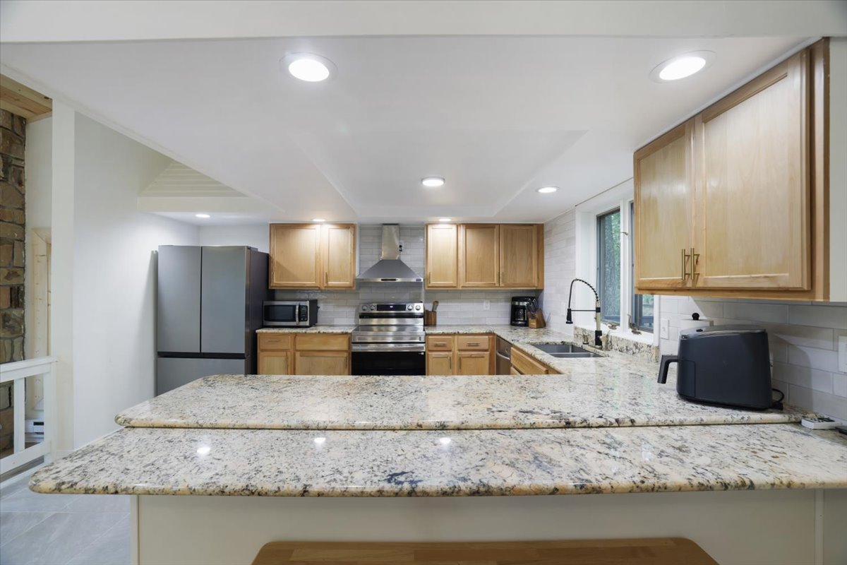 Brand-new expansive kitchen and stone countertop bar top